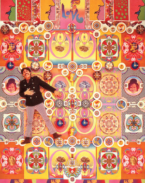 Peter laying on a floor covered in his vintage posters.