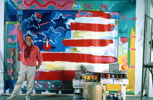 Peter standing in front of a gigantic painting of the American Flag that he painted.
