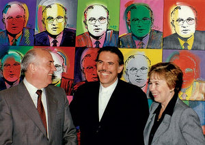 Peter Max standing with Russian President Mikhail Gorbachev and his wife in front of the '40 Gorby's' painting installation. Each painting is of Gorbachev's portrait done in a different color style.