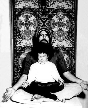 Peter max sitting cross-legged with daughter Libra in his lap