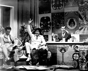 Peter Max waiving to the crowd on the Johnny Carson show.